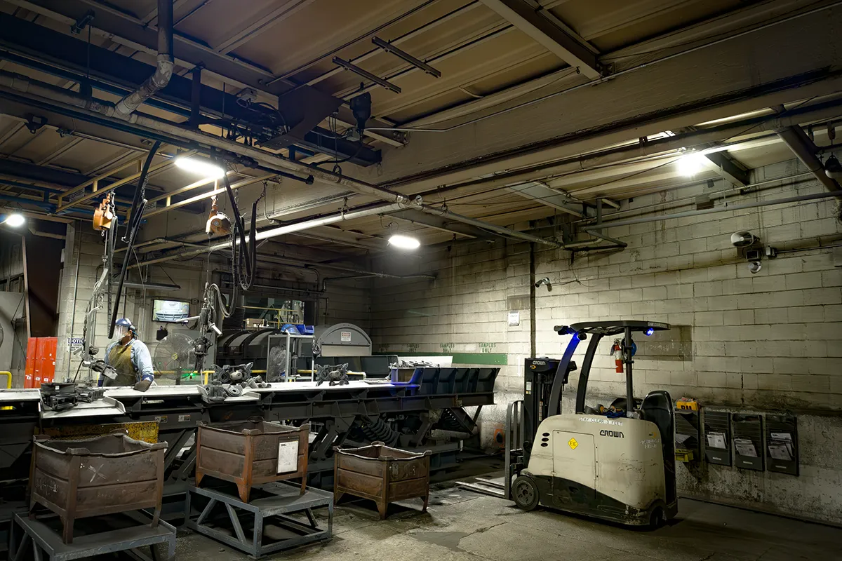 Professional with tablet in manufacturing facility