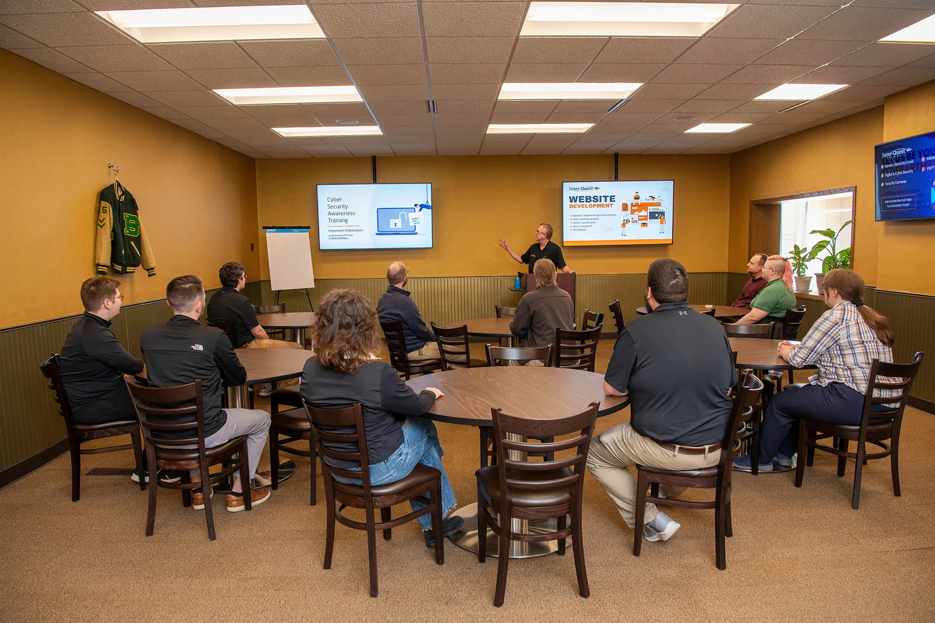 Presentation being given to a company seated at tables